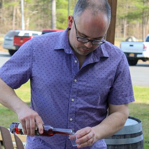 Winemaker pouring