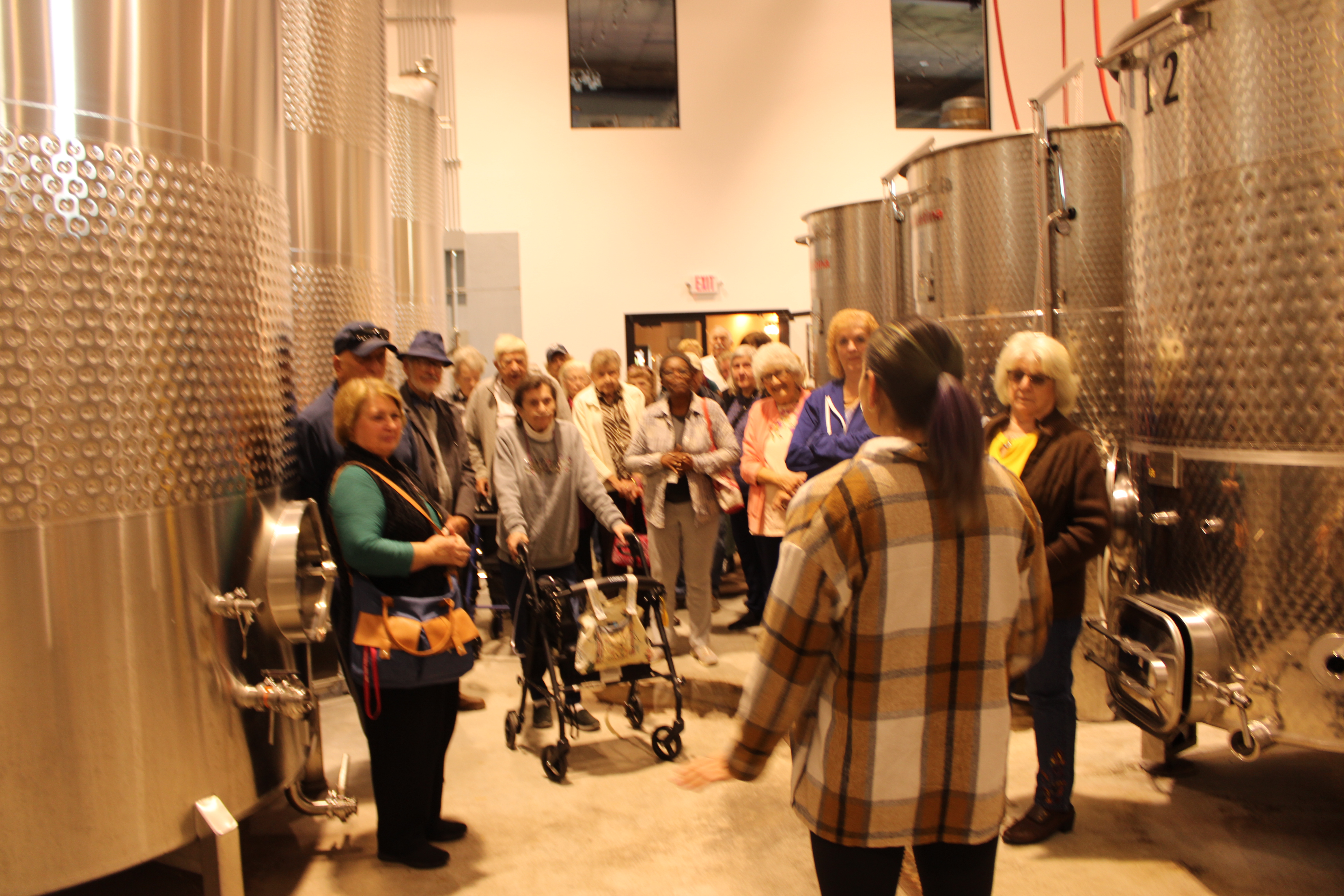 Courtney gives bus group a tour of adirondack winery