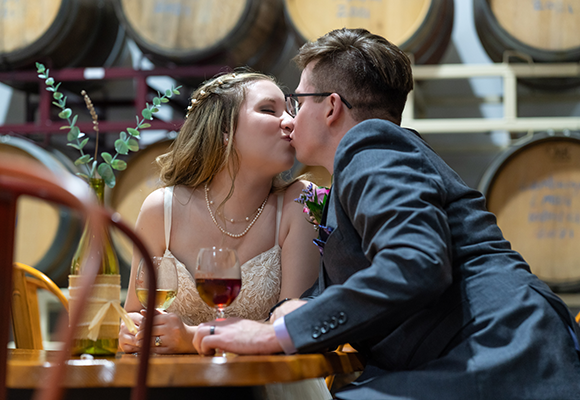 Two people kissing at an Adirondack Winery event