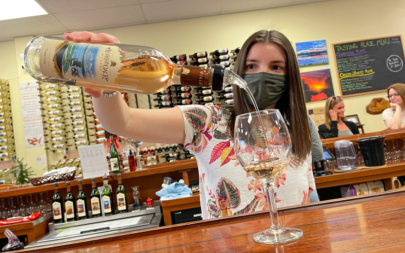 Woman pouring Pinot Gris into a glass