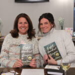 Two Women holding book at book club 800 grapes
