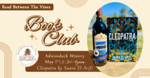 Adirondack Winery's Blue Twilight featured with a book titled Cleopatra by Saara El-arifi for Read Between the Vines Book Club book for May 1st 2026 hosted at Adirondack Winery
