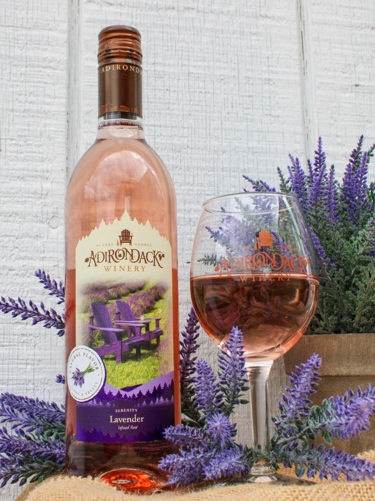 Serenity Wine Bottle with wine glass pour of Serenity, surrounded by lavender flowers